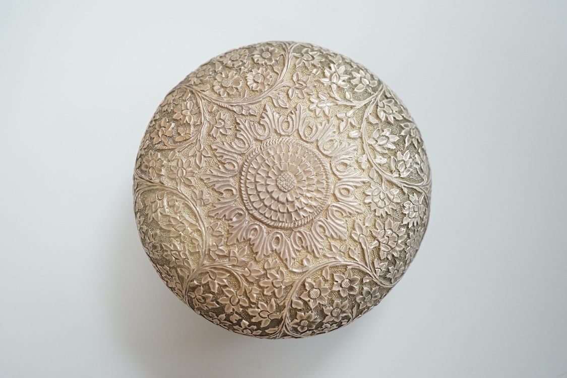 A Thai white metal tobacco box, embossed with foliage, diameter 72mm together with a similar dish.